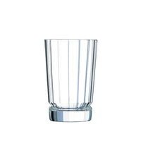 Transparent tumbler with ribbed surface, thick round base, on white background.
