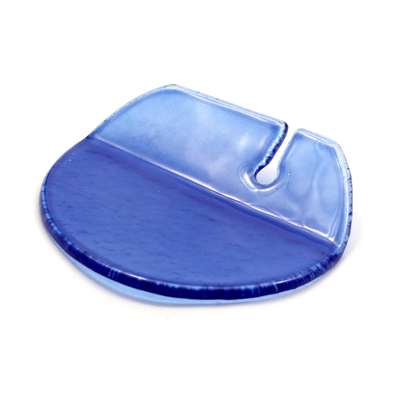 Transparent blue glass round plate with fluting and opaque top section, on white background.