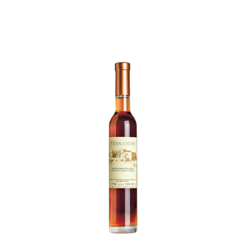 Amber liqueur or dessert wine bottle with beige label and copper-colored caps, white background