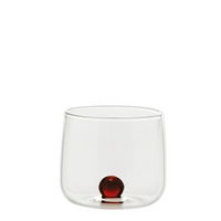 bicchiere trasparente in vetro con base piatta e sfera decorativa rossa alla base, su sfondo bianco semplice