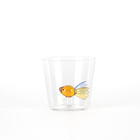 Transparent tumbler with design of an orange, blue and yellow fish, on white background.