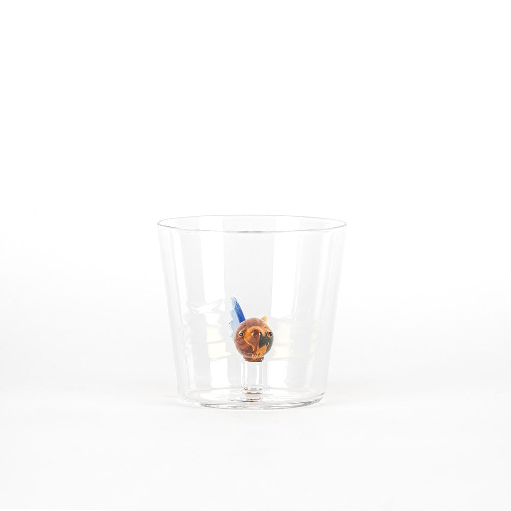 Transparent tumbler with a small animal figure inside, brown and blue in color. White background.