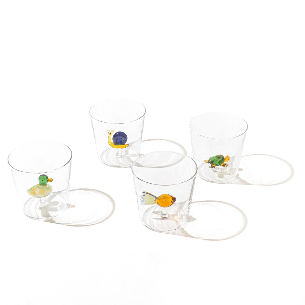 Four transparent glasses with coloured decorations: a green duck, a blue snail, a yellow fish and a green turtle.