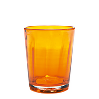 transparent orange glass tumbler in glass with slightly rounded rim on white background