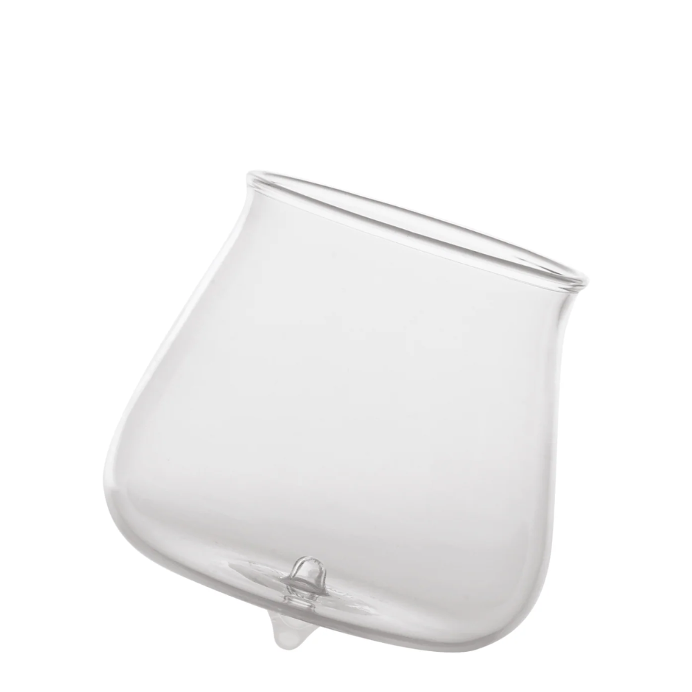 transparent glass tumbler with thin rim and base arrotondata with piccolo spuntone centrale, white background
