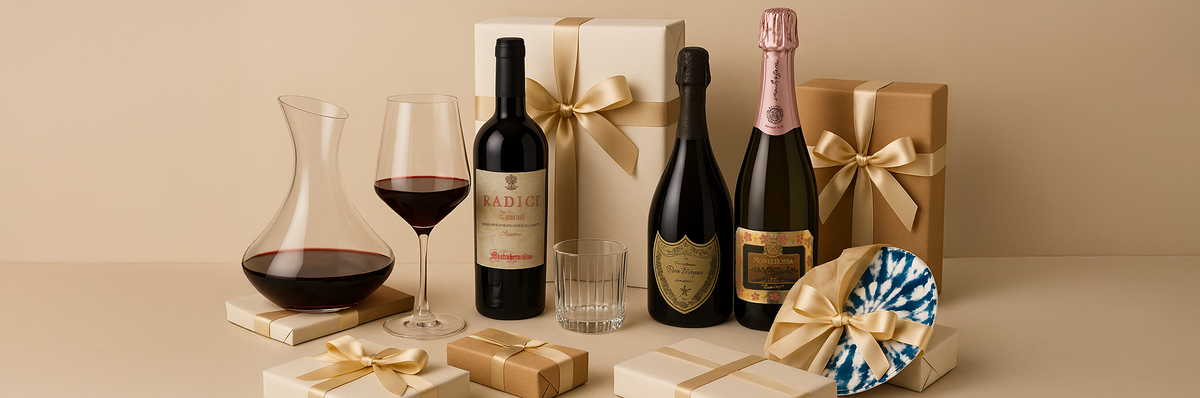 Wine and sparkling wine bottles with glass wine glass and decanter, blue and white decorative plate, beige and brown gift packages with gold ribbons on