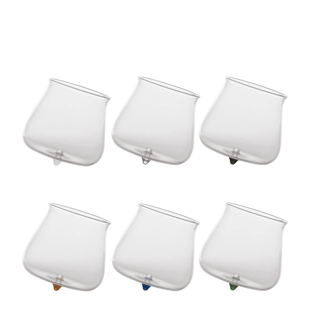 six transparent glass cups with slightly tilted base and feet in various colors on white background