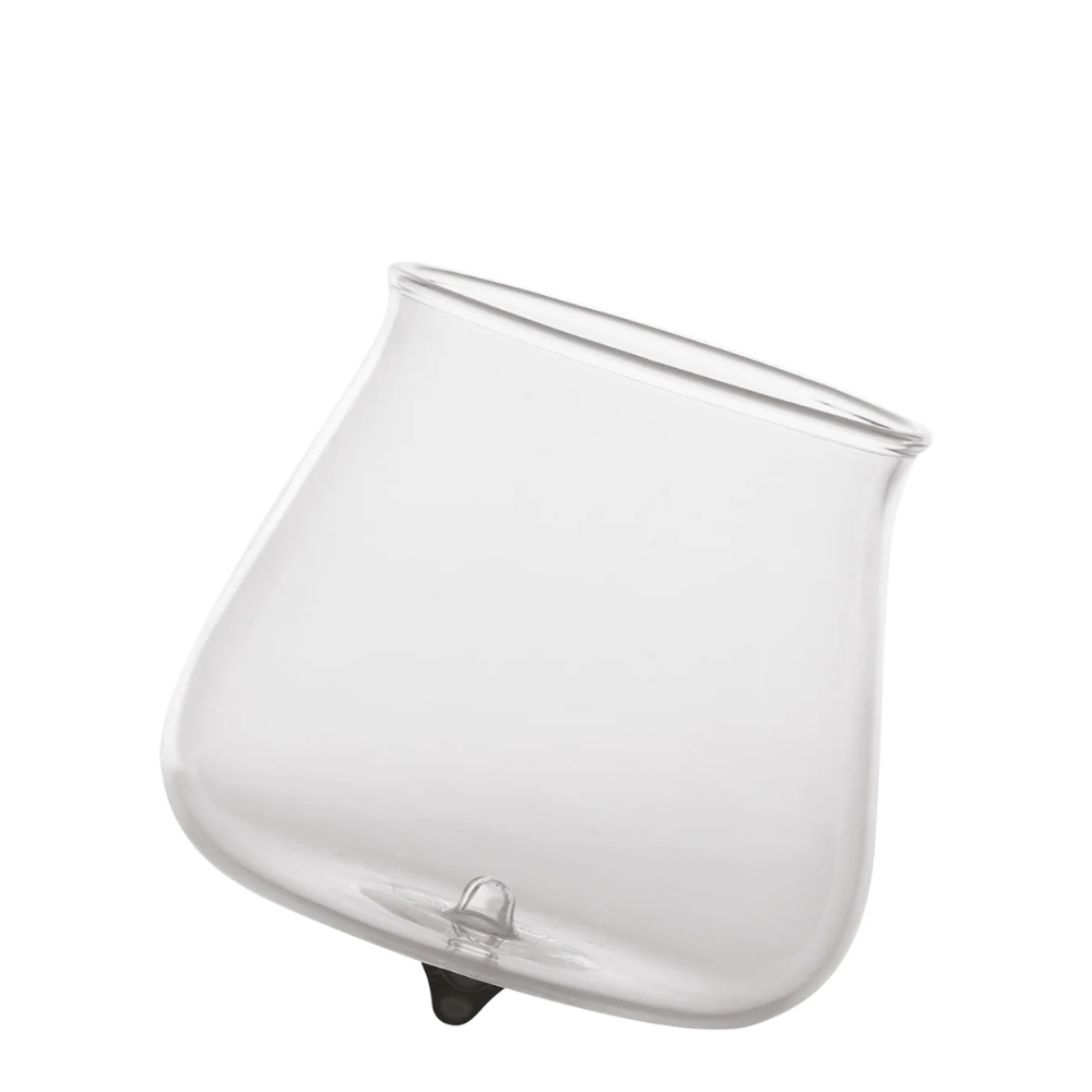 transparent glass tumbler with slightly pointed base and round mouth on white background