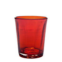 Transparent red glass tumbler with thick base and slightly tapered shape on white background