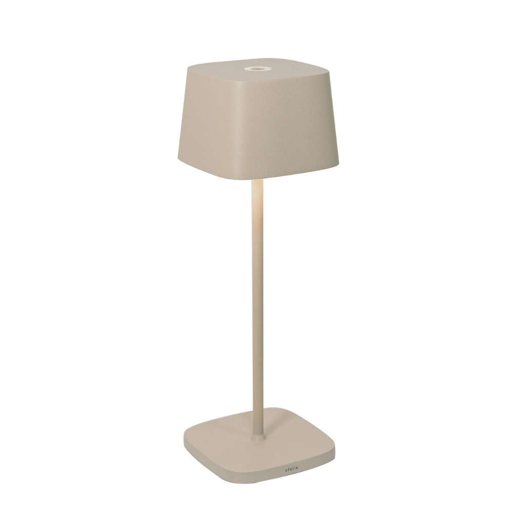 Beige table lamp with shade and square base in matte metal, modern design, white background