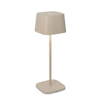 Beige table lamp with shade and square base in matte metal, modern design, white background