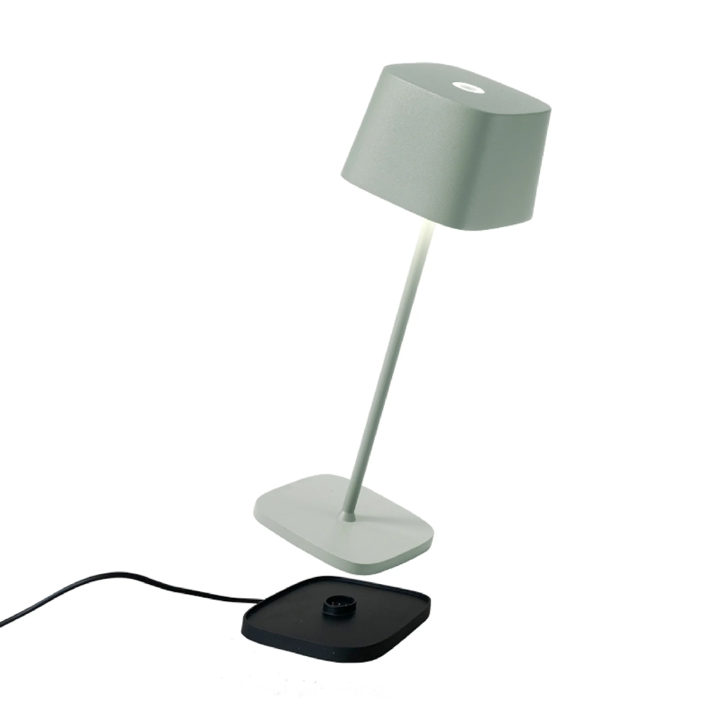 Sage green table lamp with separate black base and black cord on white background