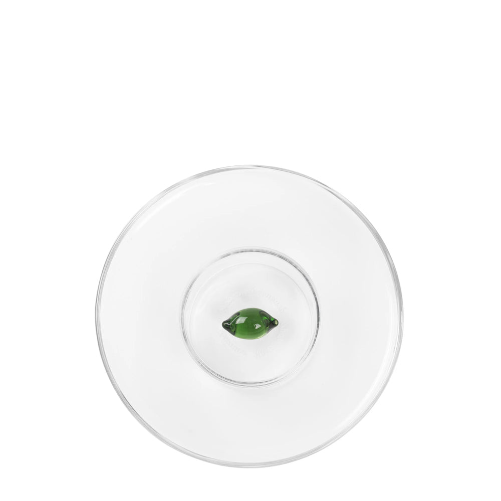 Sottopiatto trasparente circolare con una gemma verde centrata sopra, su sfondo bianco.