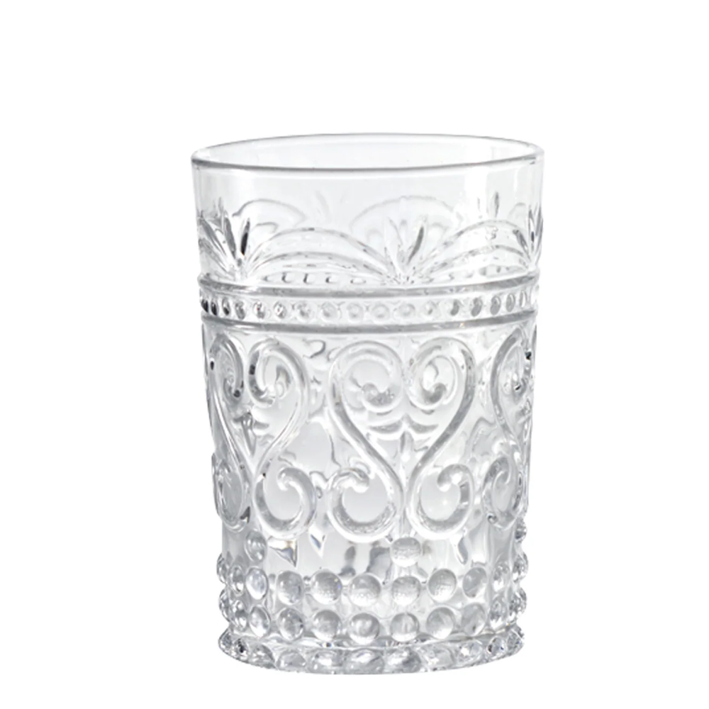 Transparent glass tumbler with raised floral and dot decorations, bubble base, white background.