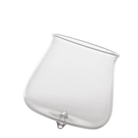 Transparent glass tumbler with rounded base and slightly raised rim on white background