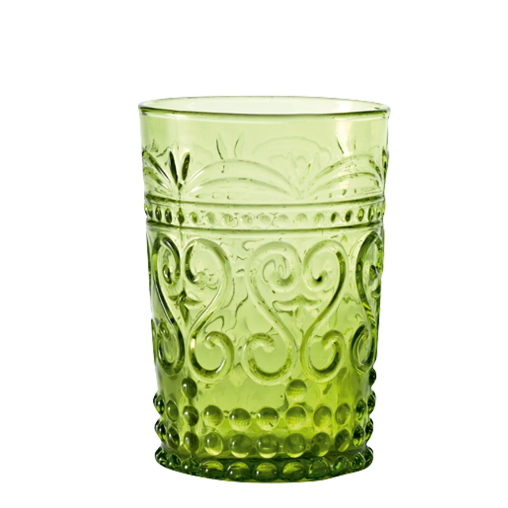 Transparent green glass tumbler with carved floral and bubble decorations, white background.