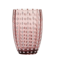 pink glass tumbler with white polka dot patterns, slightly shaped cylindrical form, white background